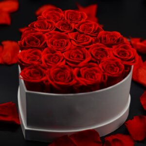 Romantic Red Preserved Rose Heart Box with Falling Petals on Black Background